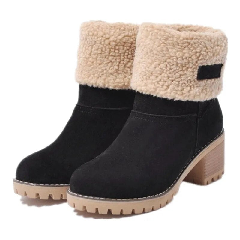Black ankle boots shown as a pair from a front three-quarter angle, with beige fold-over cuffs, rounded toes, block heels, and rugged soles.