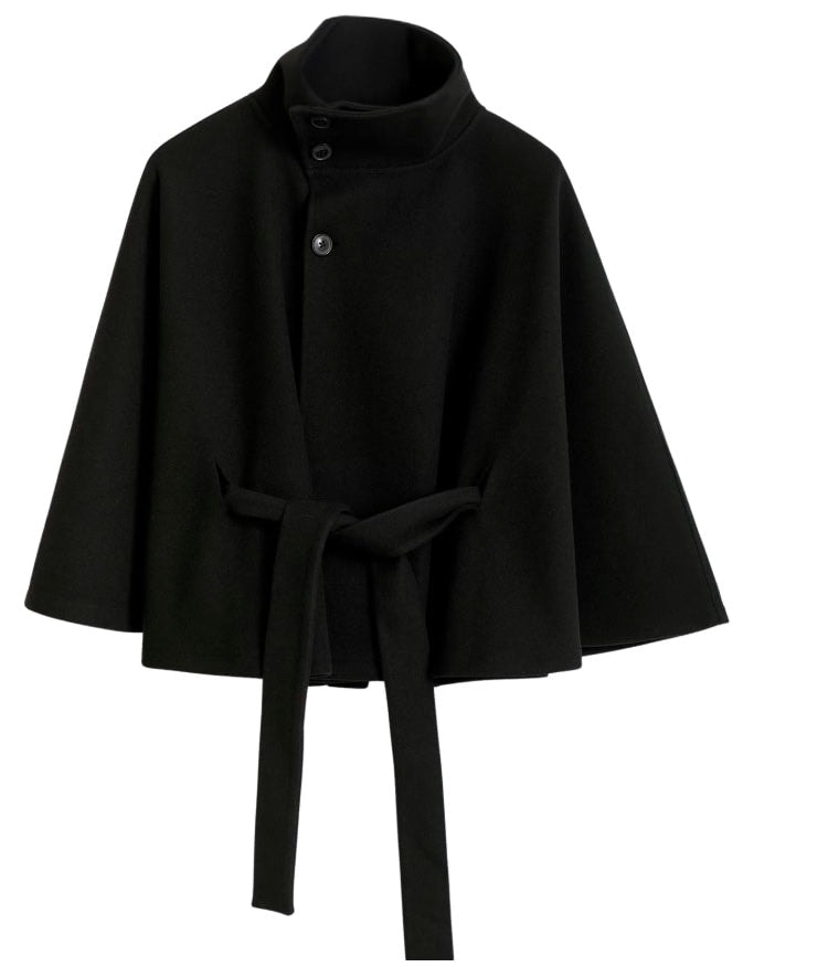 Black cape jacket shown front-facing against a light background, with a stand collar, button closure, flared sleeves, and hanging waist ties.