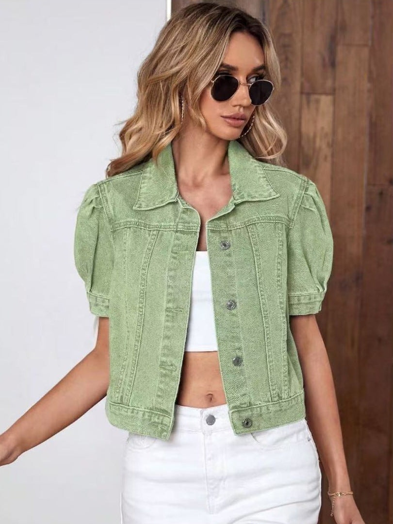 Light green cropped jacket shown with puff short sleeves, a point collar, chest pockets, and front buttons.