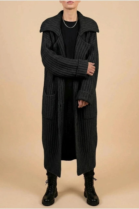 Woman wearing a long open front chunky rib knit cardigan with an oversized fold over collar, two patch pockets and ribbed cuffs, over a top and trousers with lace up boots._1