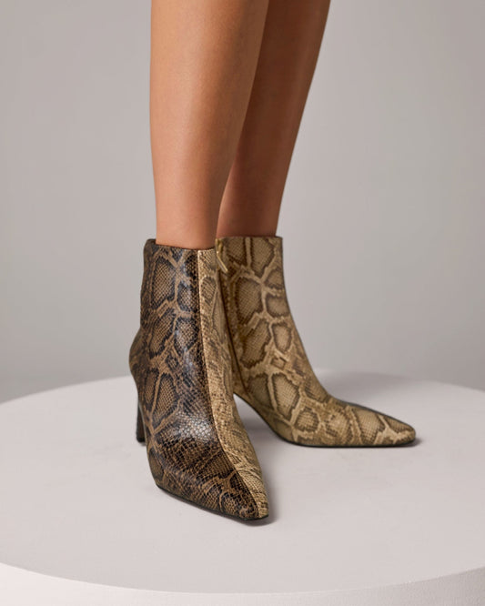 Ankle boot with snakeskin print, block heel, and square toe shown in profile against a light gray background._1