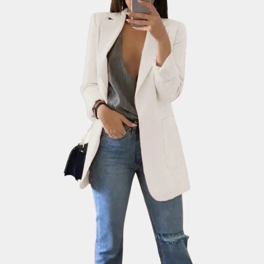 Cream longline blazer jacket with structured shoulders, notched lapels, and a single visible front pocket.