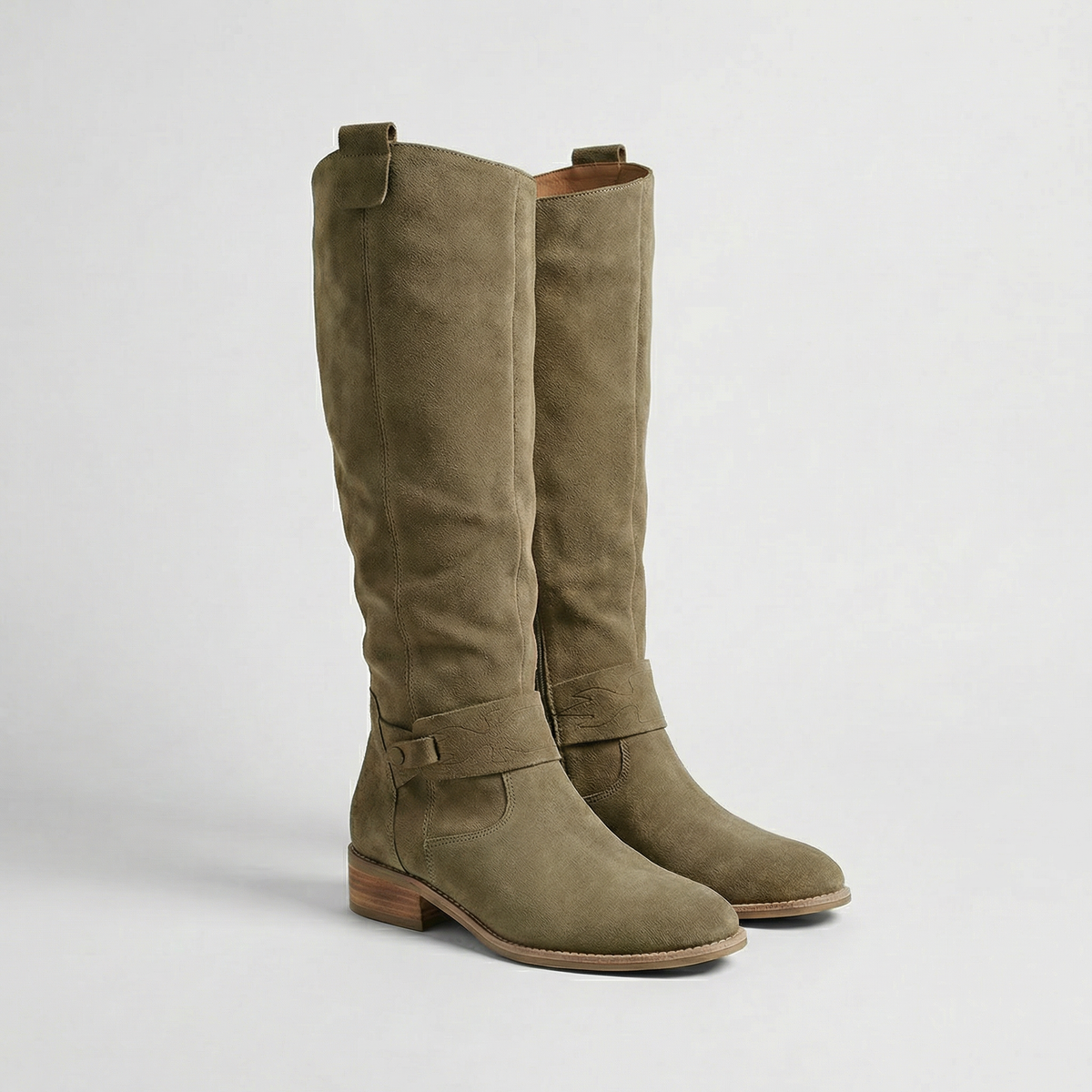 Olive taupe knee-high slouch boots shown as a pair with rounded toes, buckle details, and low stacked heels.