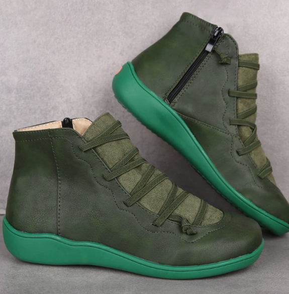 Dark green women's lace-up ankle boots arranged against a gray background, clearly showing the side zip, laces, and green soles.