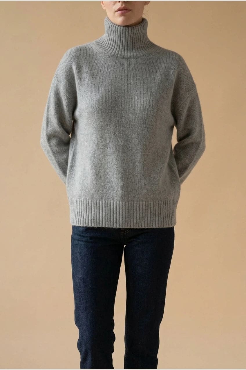 Woman wearing a relaxed roll neck jumper with ribbed collar, cuffs and hem, with straight-leg jeans and ankle boots._1