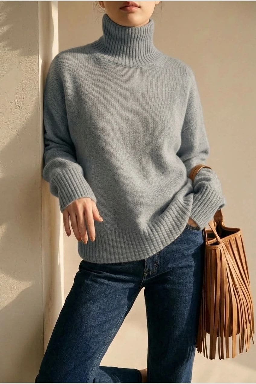 Woman wearing a relaxed roll neck jumper with ribbed collar, cuffs and hem, with straight-leg jeans and ankle boots._2