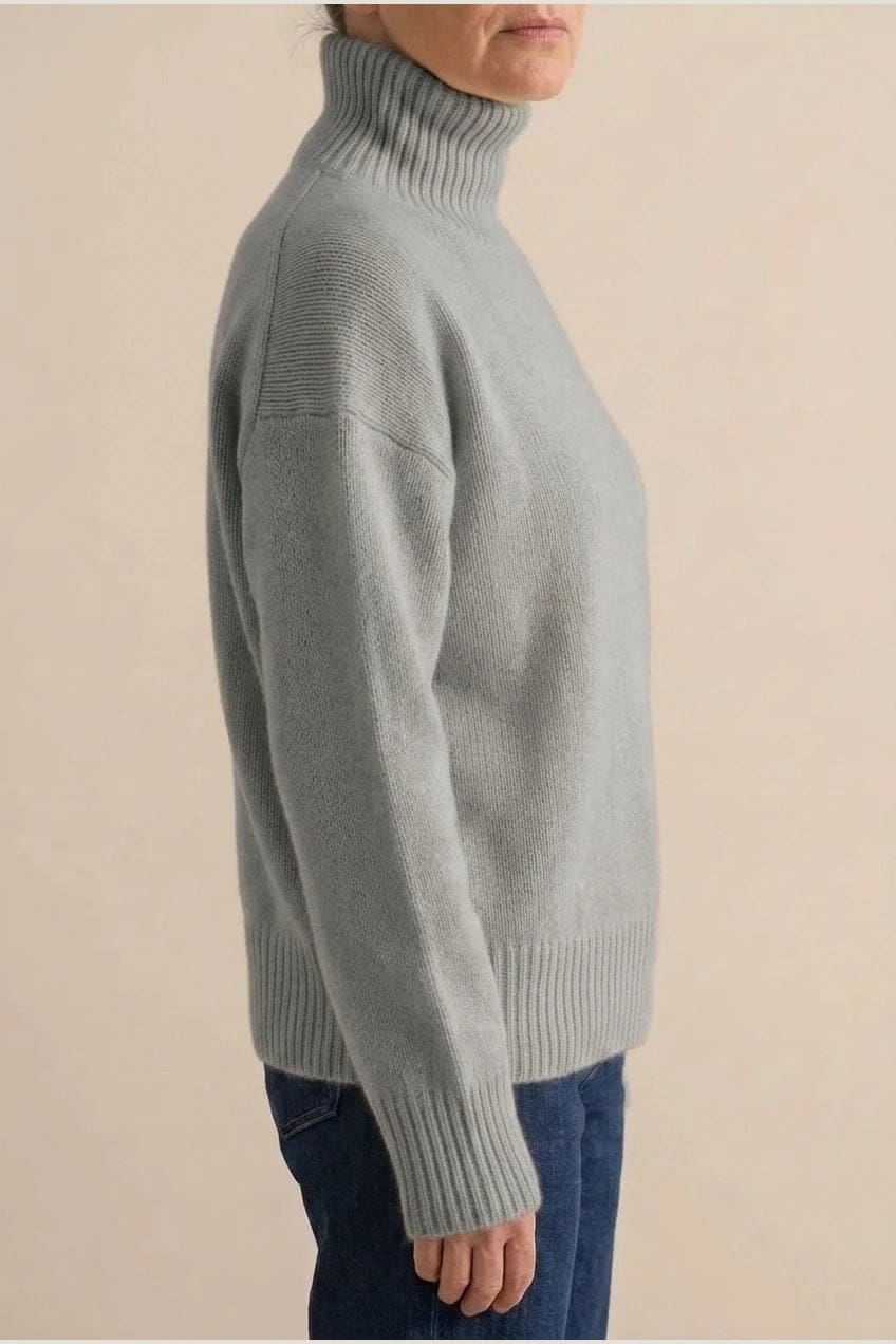 Woman wearing a relaxed roll neck jumper with ribbed collar, cuffs and hem, with straight-leg jeans and ankle boots._3