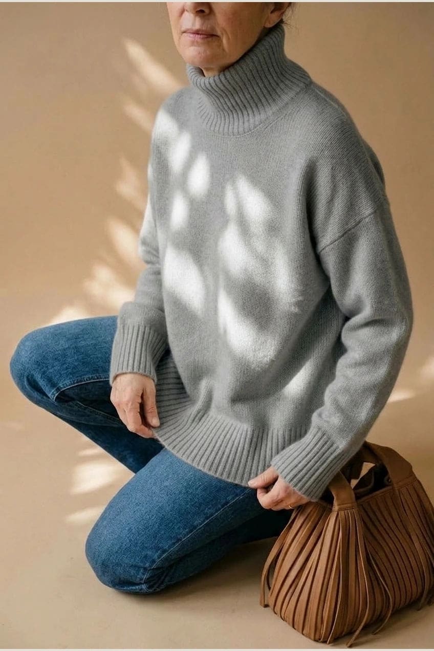 Woman wearing a relaxed roll neck jumper with ribbed collar, cuffs and hem, with straight-leg jeans and ankle boots._4