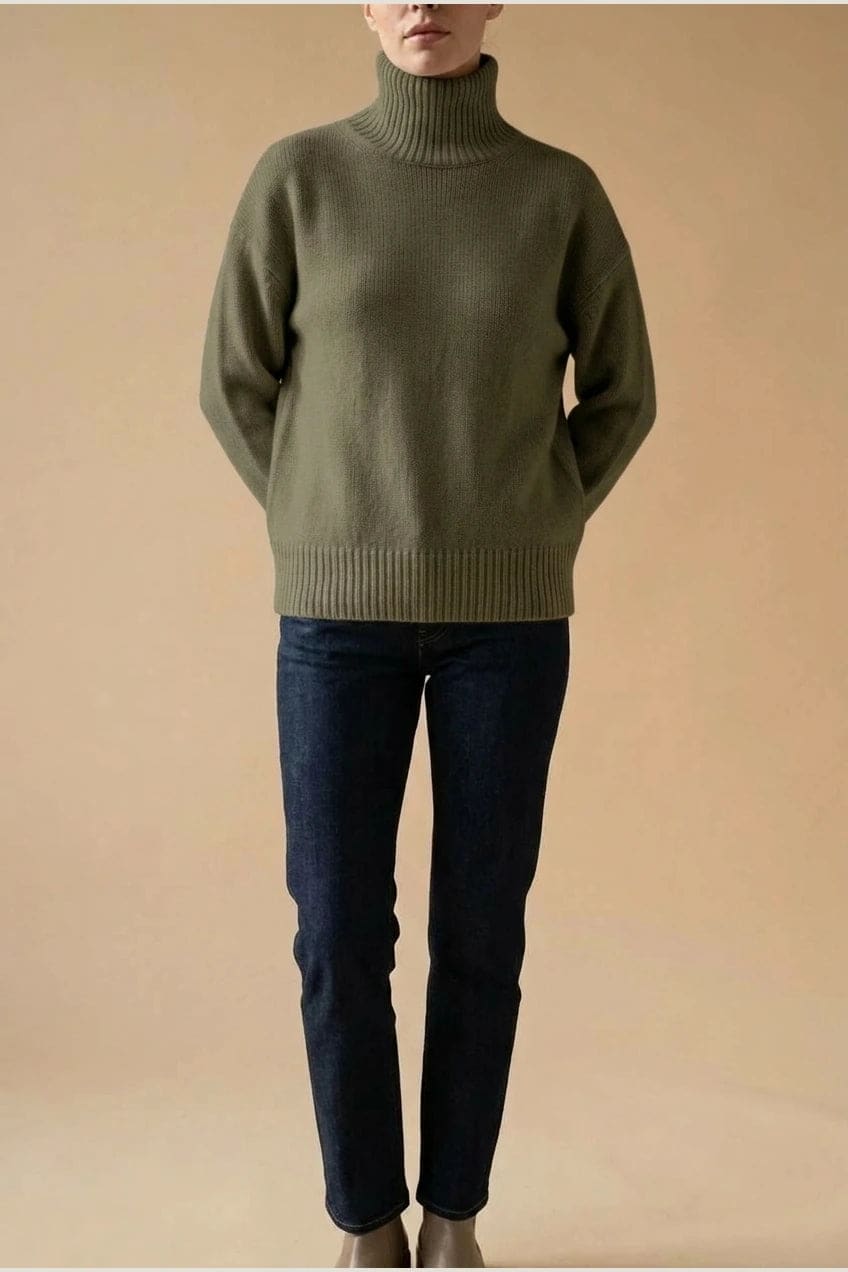 Woman wearing a relaxed roll neck jumper with ribbed collar, cuffs and hem, with straight-leg jeans and ankle boots._7