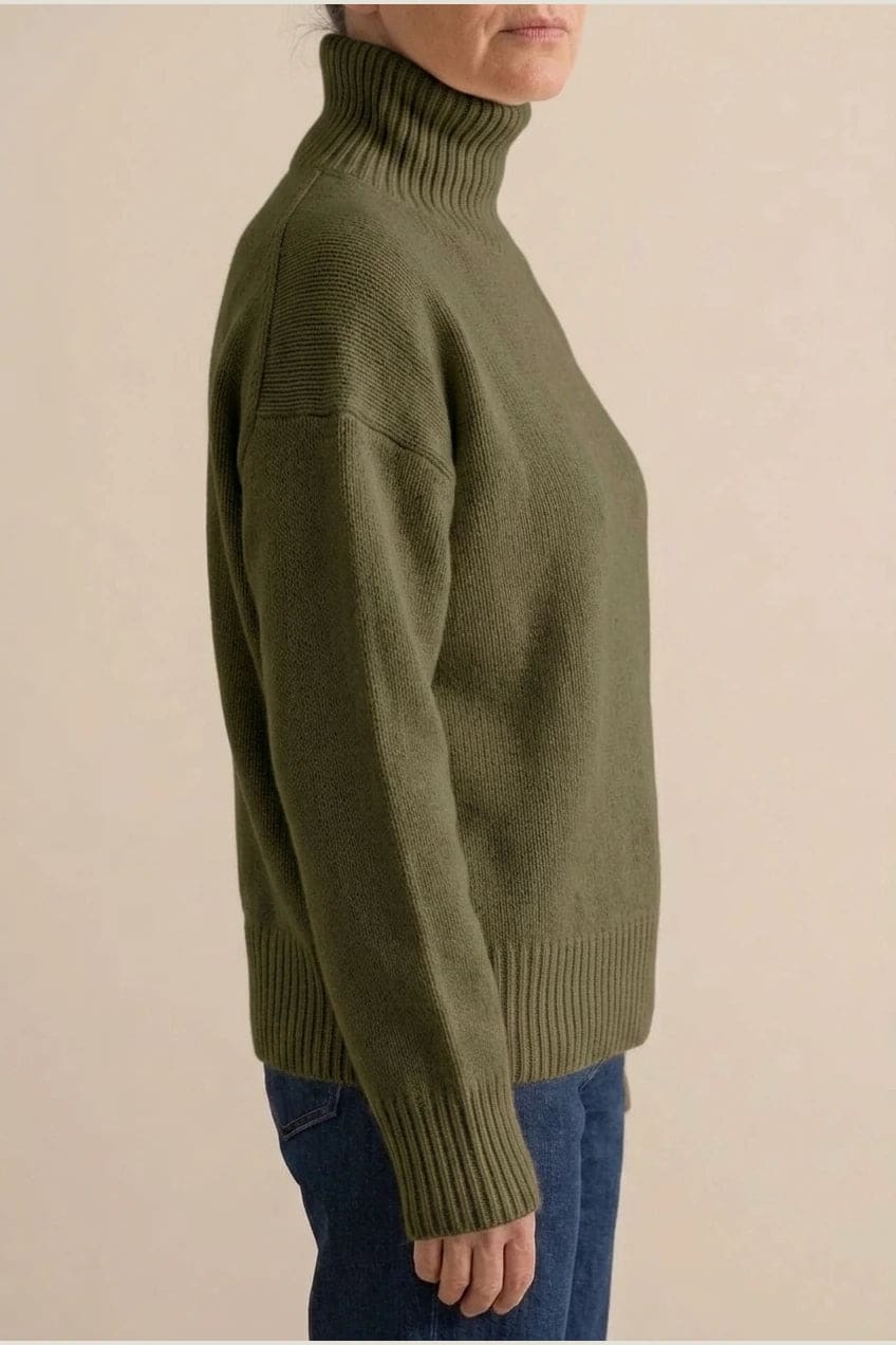 Woman wearing a relaxed roll neck jumper with ribbed collar, cuffs and hem, with straight-leg jeans and ankle boots._9