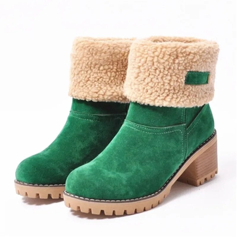 Green ankle boots displayed as a pair, with plush beige fold-over cuffs, rounded toes, stacked block heels, and rugged treaded soles.