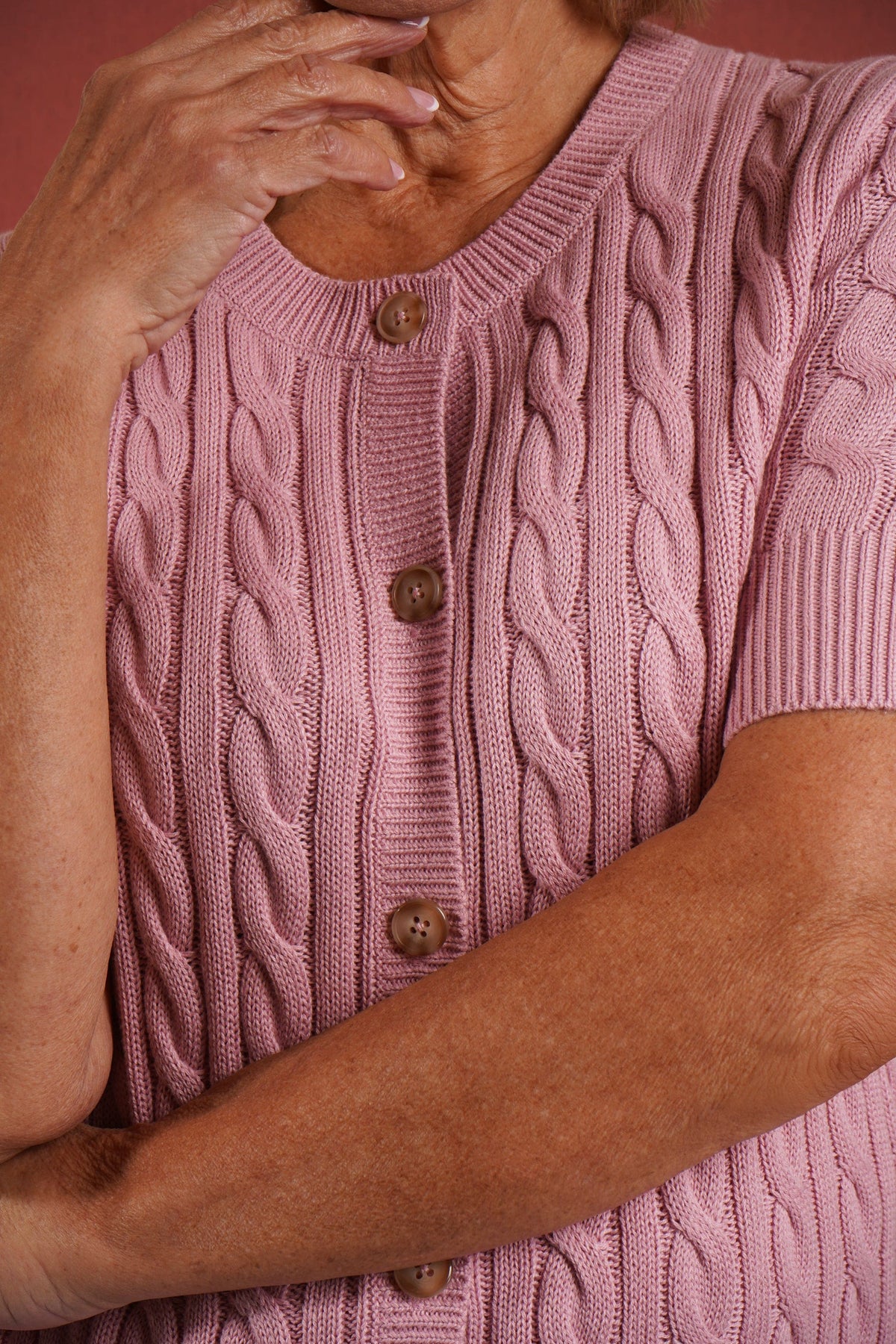 Short sleeve cable knit cardigan with round neckline, ribbed cuffs and hem, and a full row of front buttons._4