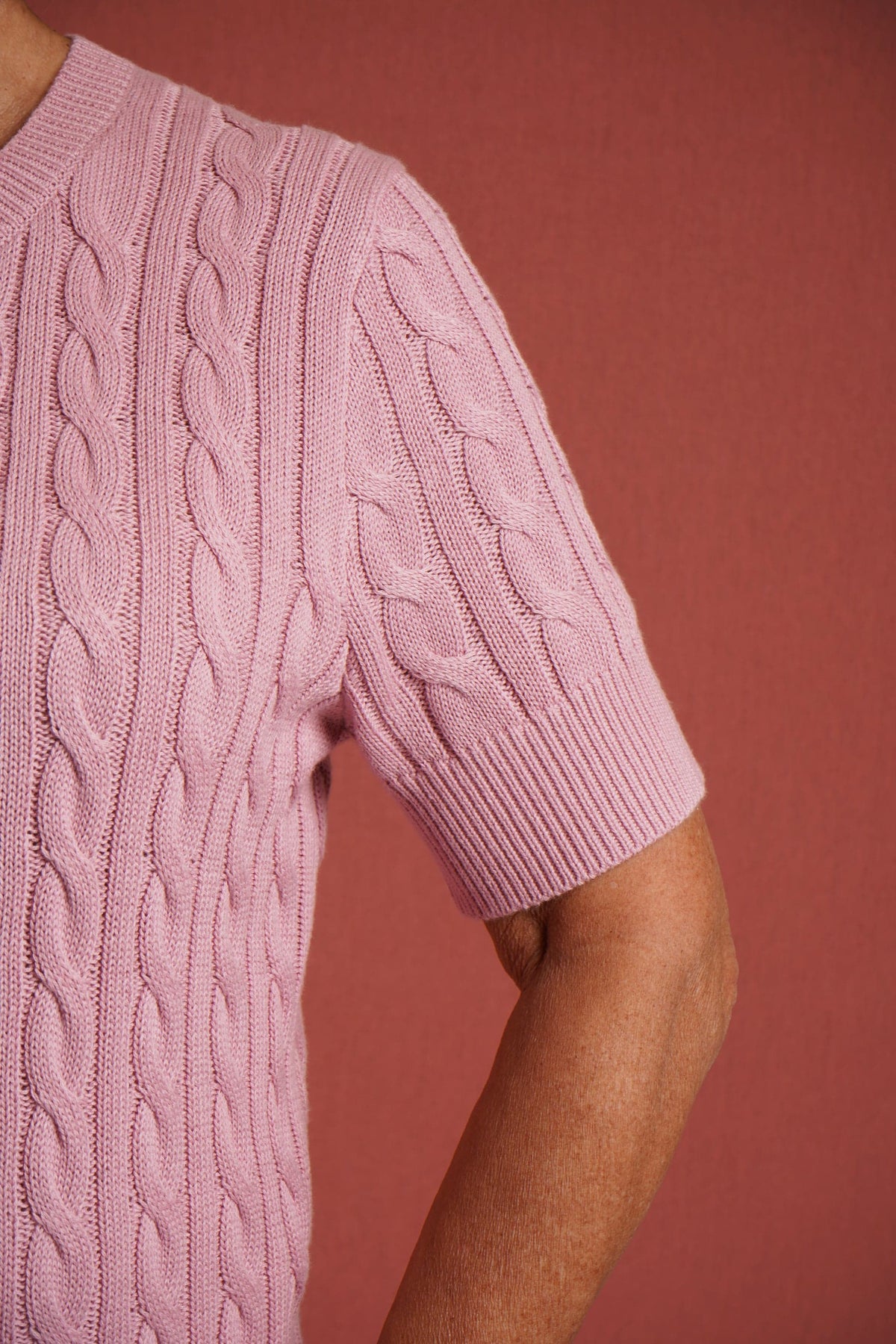 Short sleeve cable knit cardigan with round neckline, ribbed cuffs and hem, and a full row of front buttons._5
