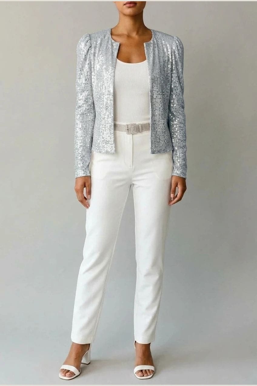 Model wearing an open-front cropped sequin jacket with long sleeves and structured shoulders over a tank top and tailored trousers._7