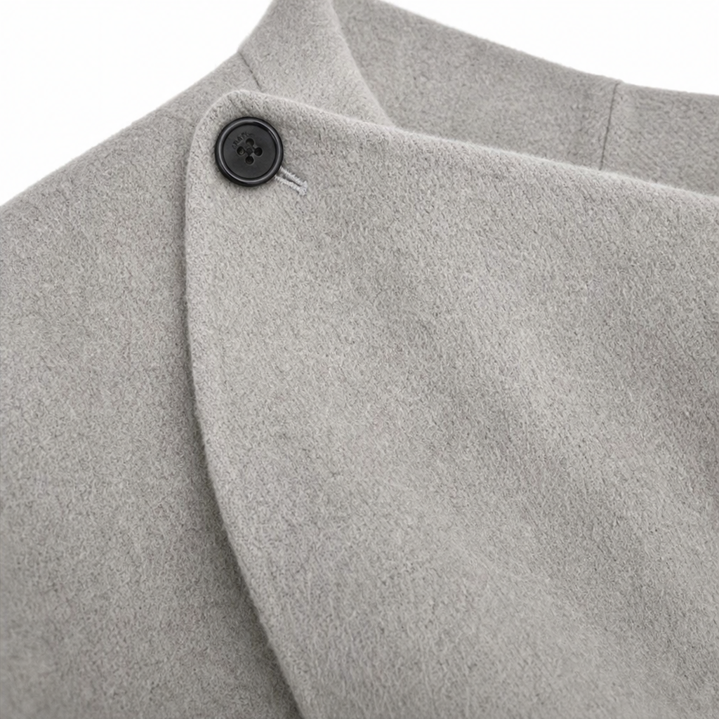 Detail of the light gray jacket's buttoned collar and overlapping asymmetric wrap front.