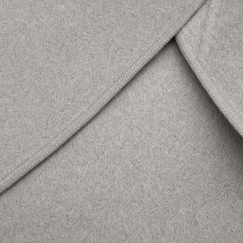 Close-up showing the jacket's finished edge stitching along the overlapping wrap panels.