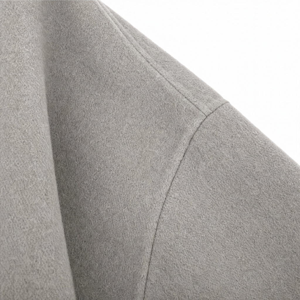 Detail of the jacket's wide sleeve and visible seam construction.