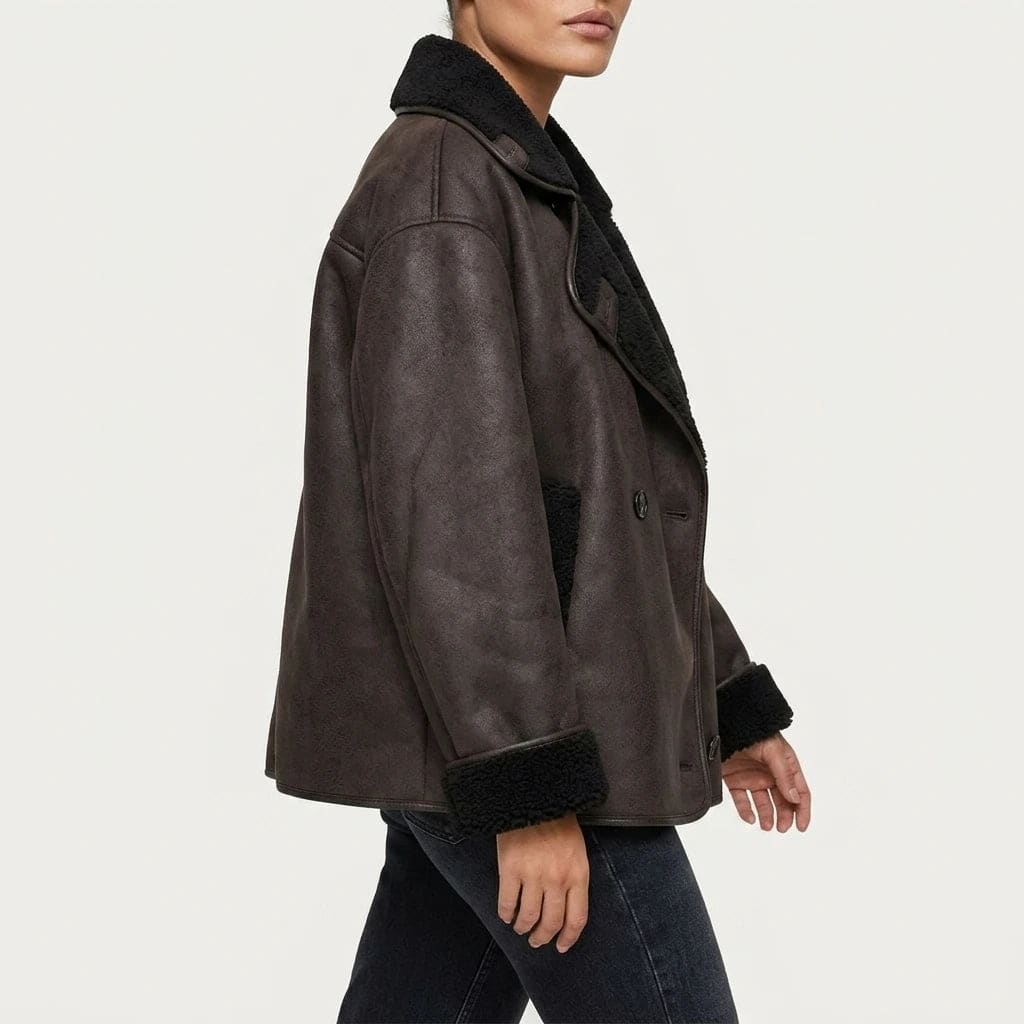 Oversized hip length jacket with wide shearling lined lapels, turn back cuffs, two button front and front pockets, worn open over a tee and straight jeans._2