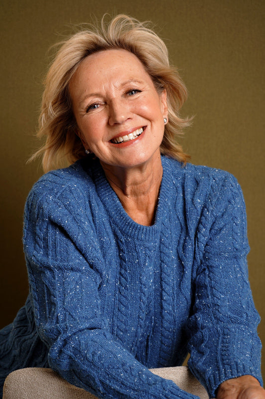 Woman wearing a flecked cable knit crew neck jumper with long sleeves and ribbed trims, with dark trousers._2