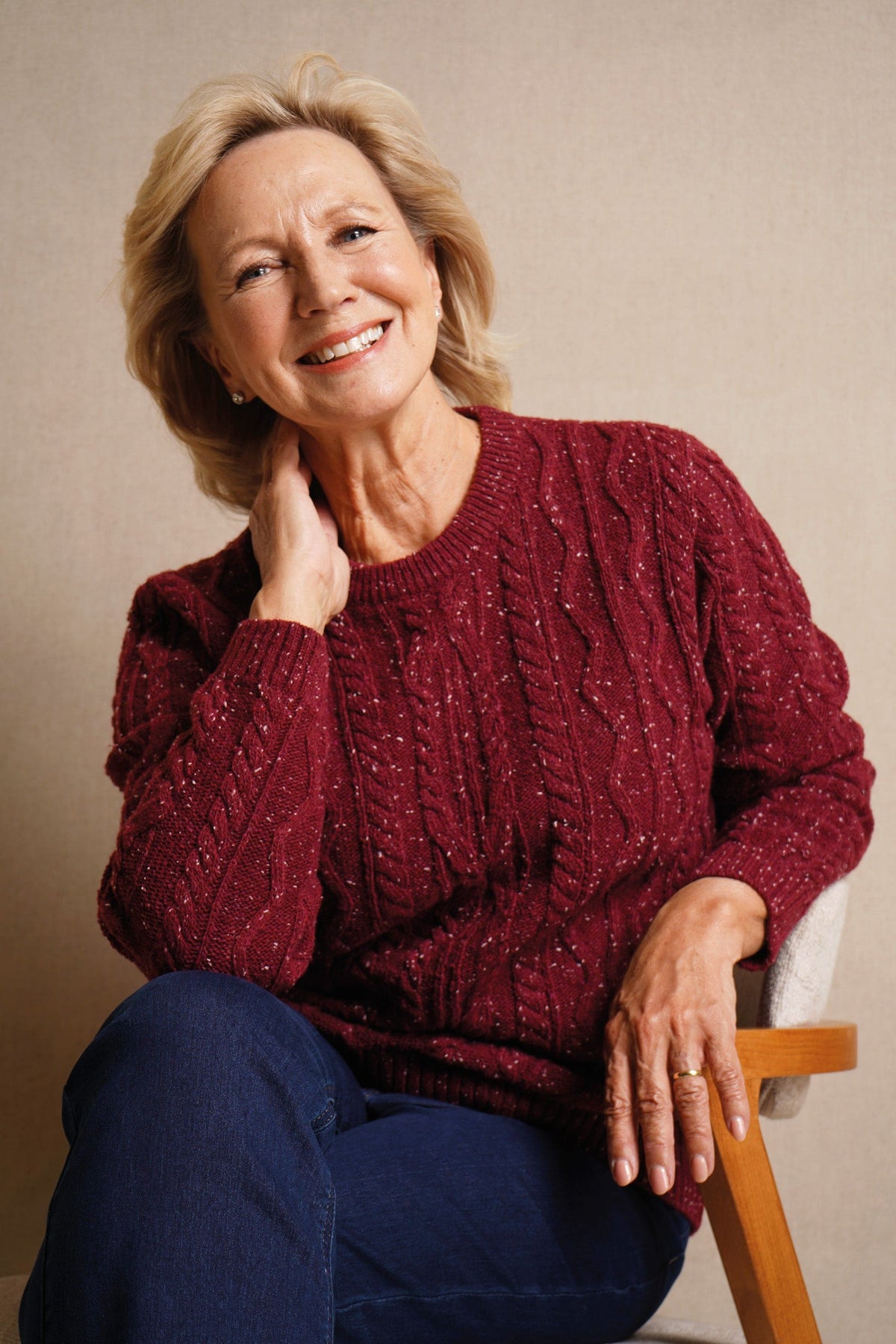 Woman wearing a flecked cable knit crew neck jumper with long sleeves and ribbed trims, with dark trousers._3