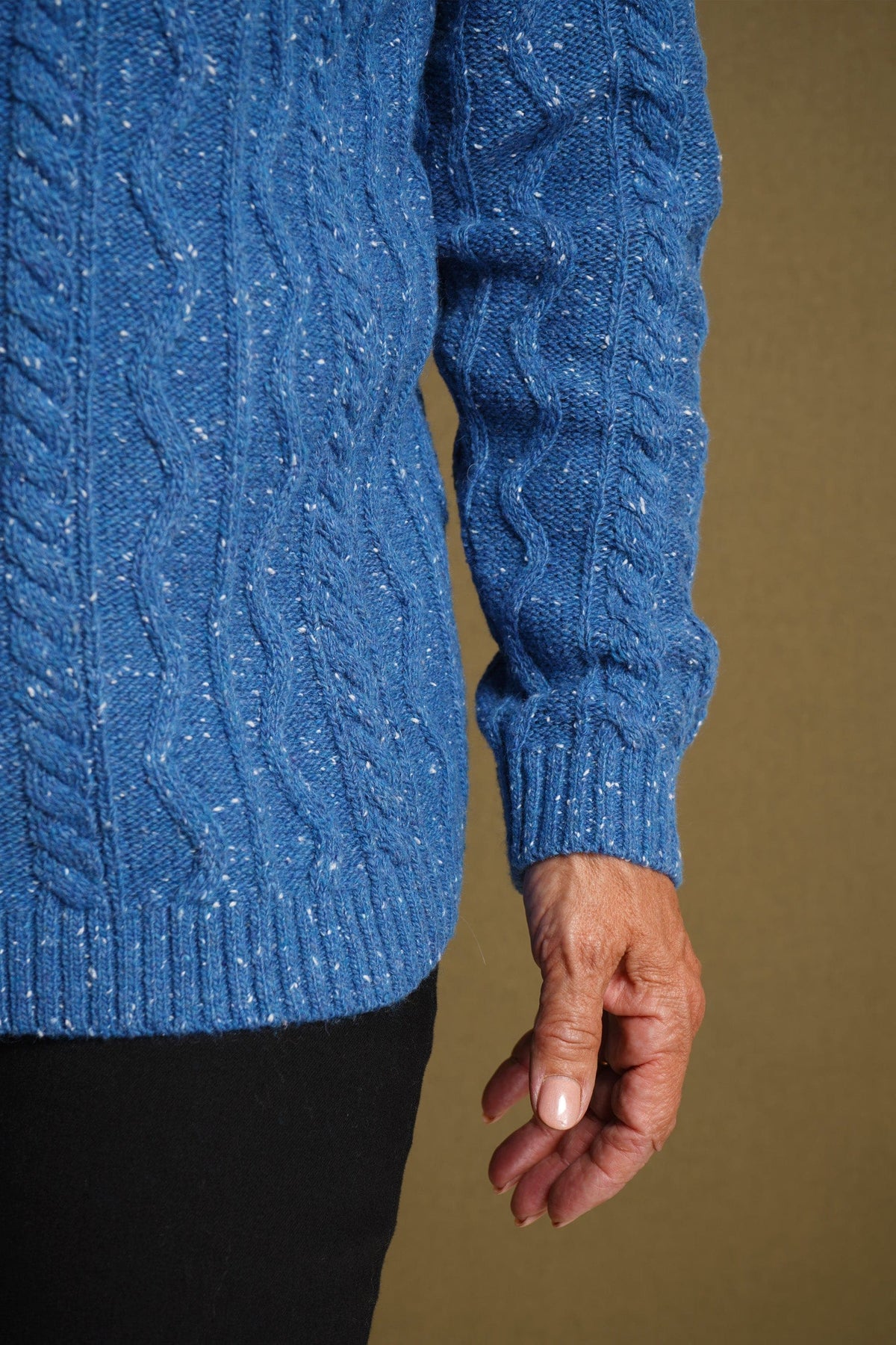 Woman wearing a flecked cable knit crew neck jumper with long sleeves and ribbed trims, with dark trousers._4