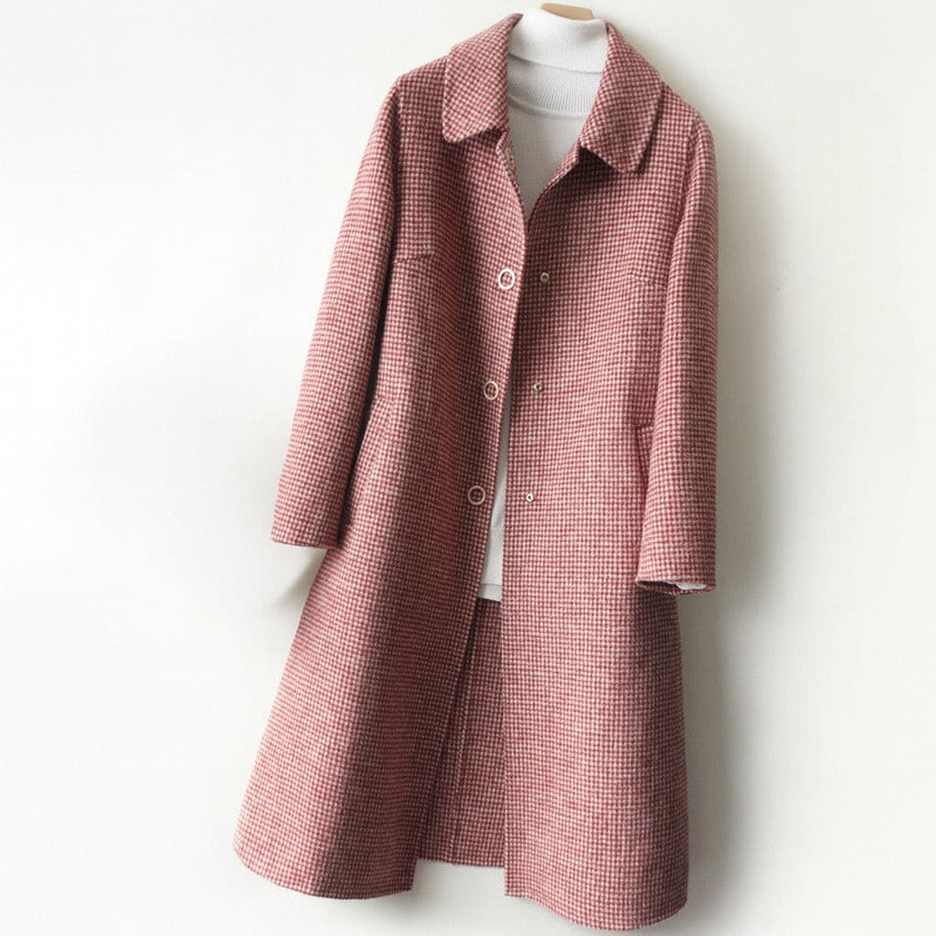 A longline check coat with a point collar, button front, and side pockets displayed on a hanger._0