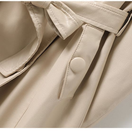 A long double-breasted trench coat with wide lapels and a tied waist belt displayed on a hanger._10