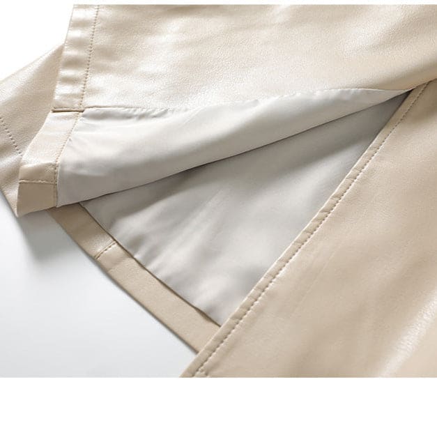A long double-breasted trench coat with wide lapels and a tied waist belt displayed on a hanger._9