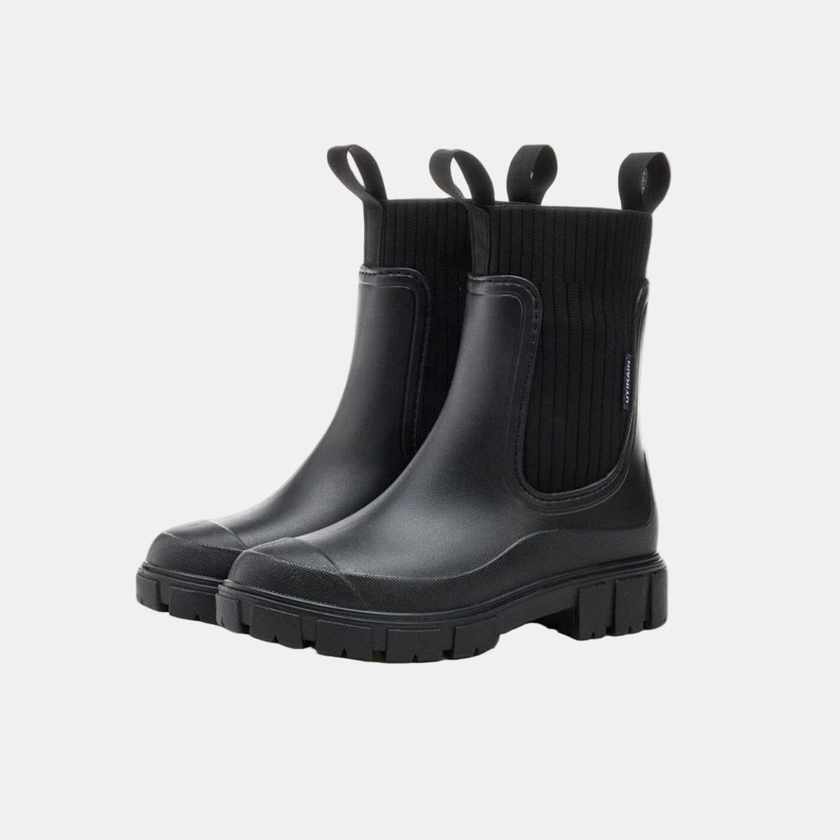 Pair of black ankle-height Chelsea boots with chunky deeply treaded soles, elastic side panels, and pull tabs, shown from a front three-quarter view.