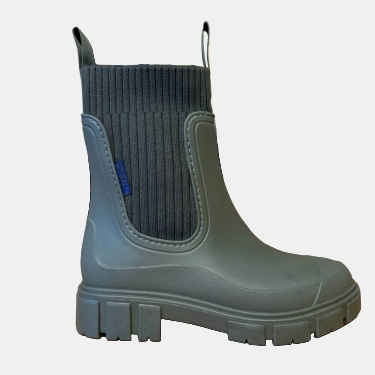 Single black Chelsea boot shown in side profile, highlighting its elastic side panel, rounded toe, pull tab, and blocky treaded sole.