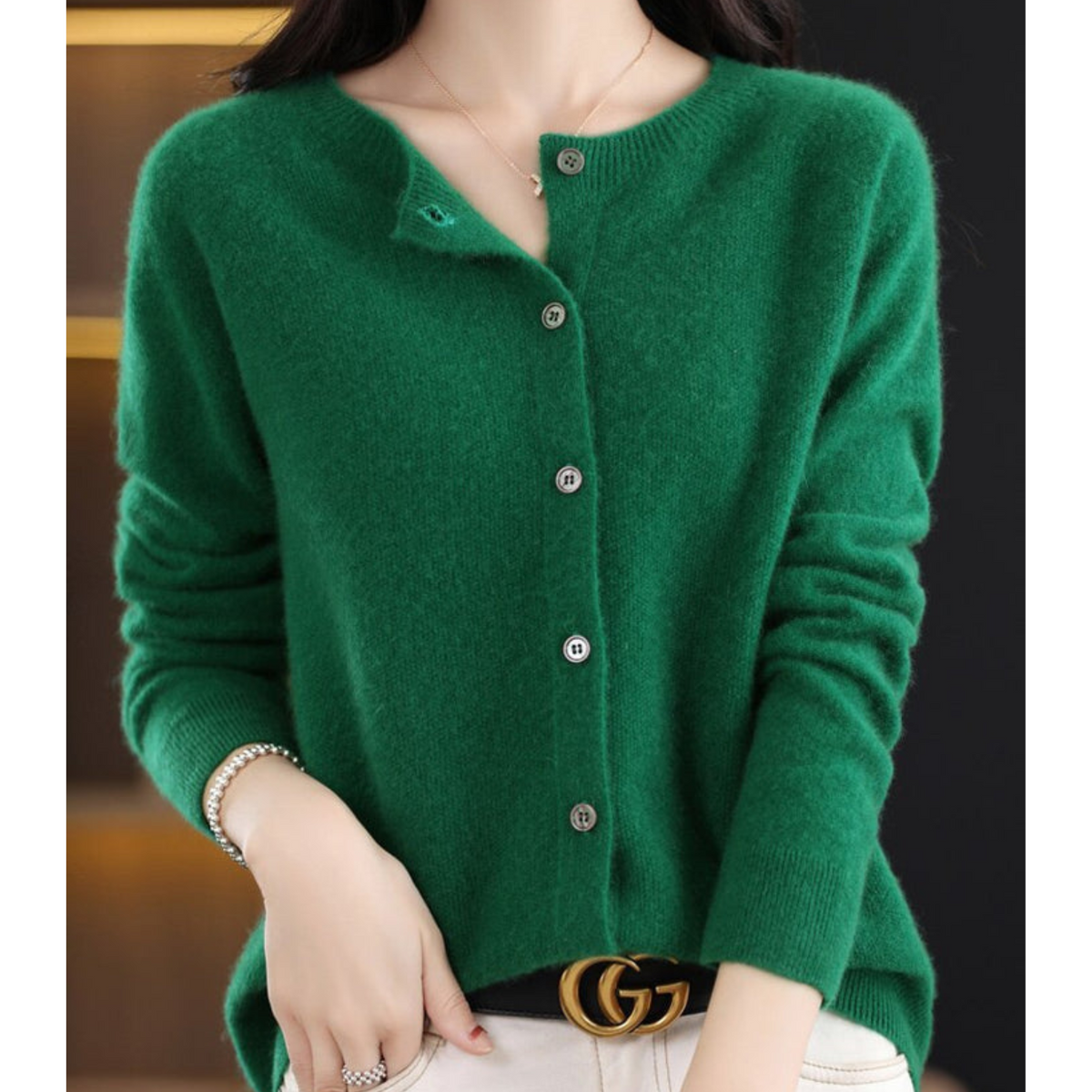 Green cardigan with an open neckline, long sleeves, and a buttoned front