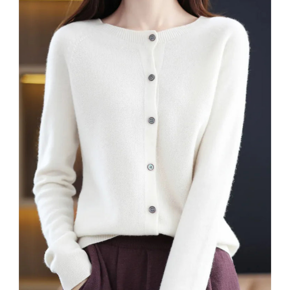 White button-front cardigan worn with dark brown trousers