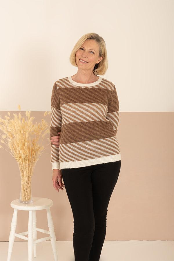 Woman wearing a long sleeve crew neck jumper with wide diagonal stripes and ribbed neck, cuffs and hem, with trousers._3