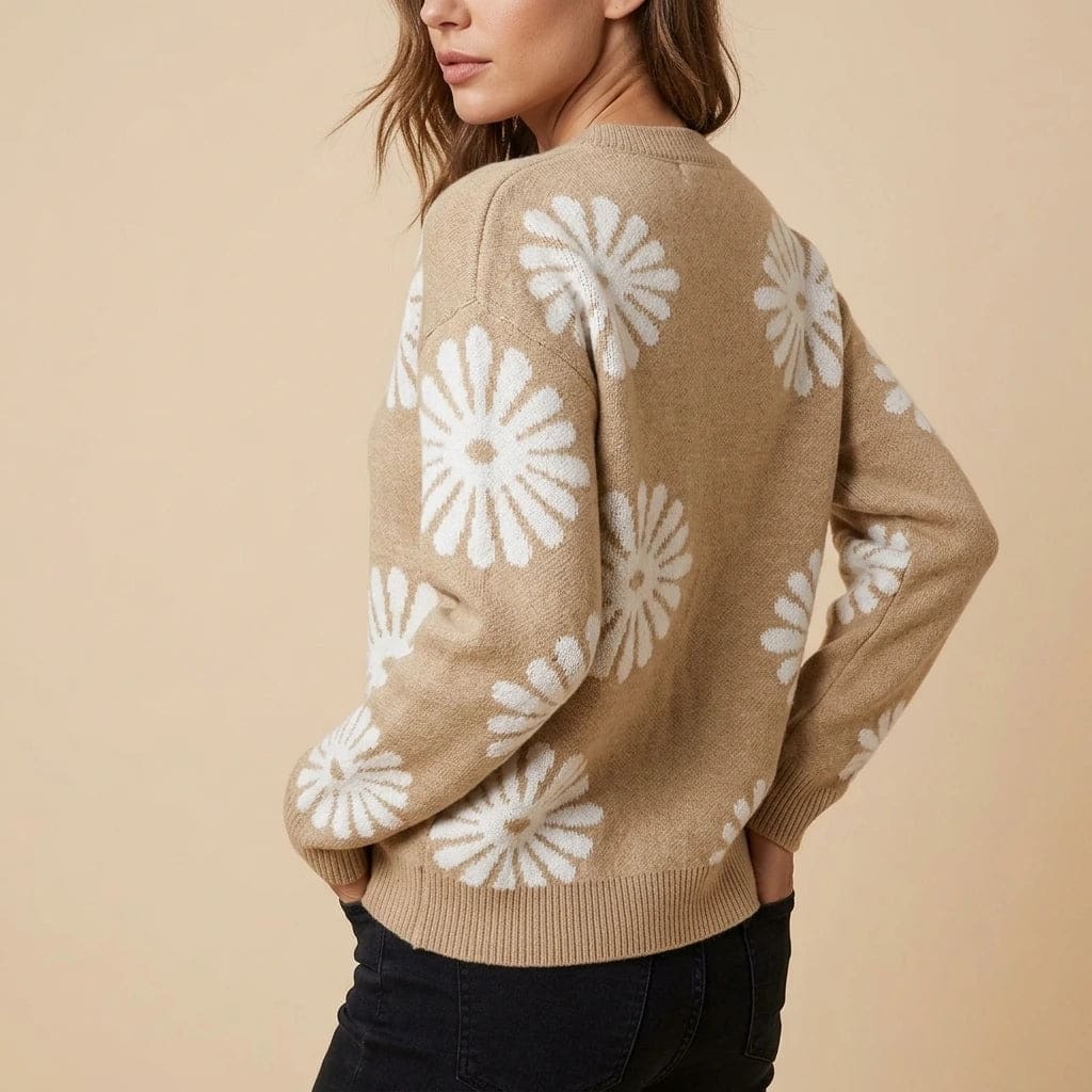 Woman wearing a relaxed crew neck knit jumper with large daisy motifs, blue jeans and low trainers._2