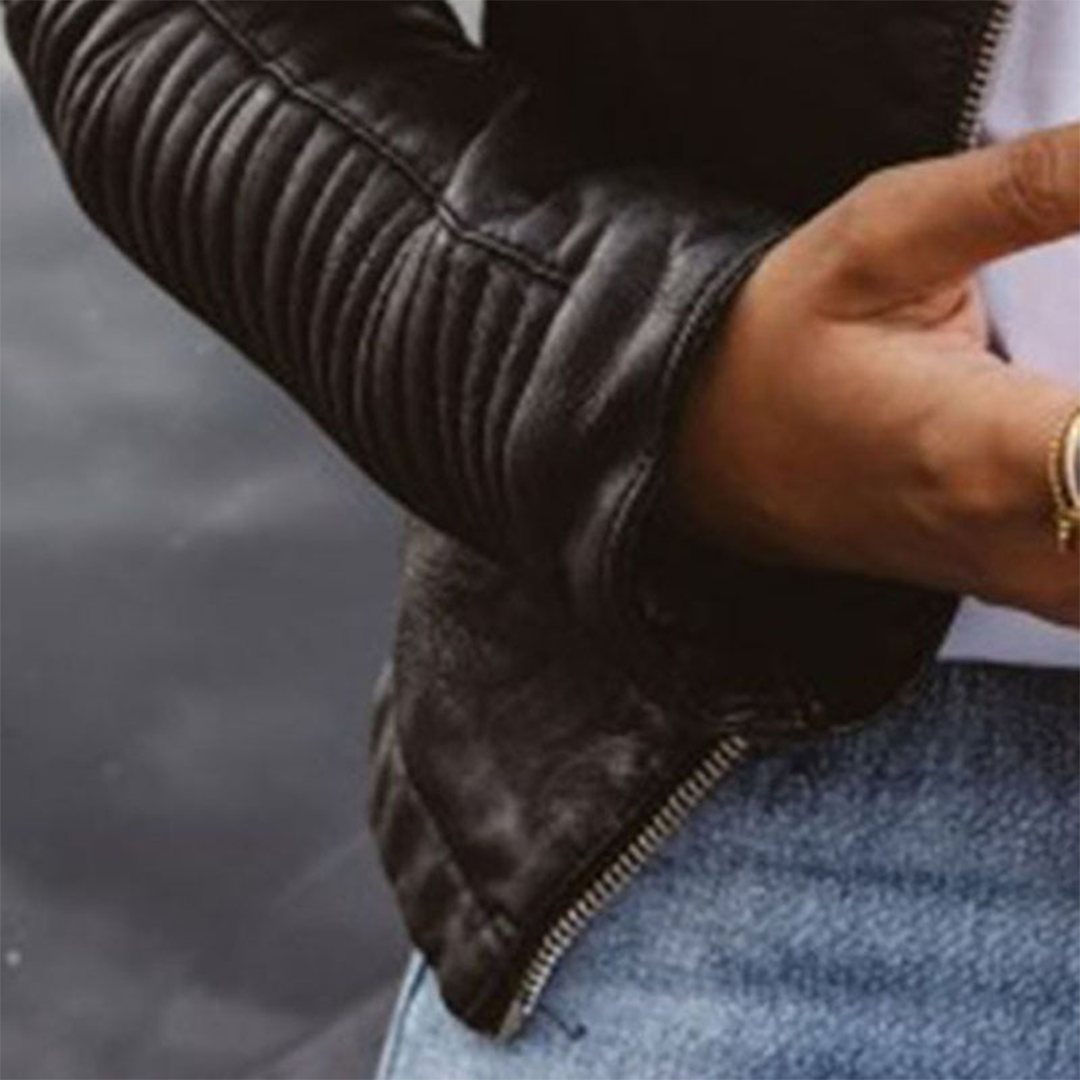 Close-up of the jacket’s ribbed quilted sleeve, cuff, lower hem, and side zip detail.