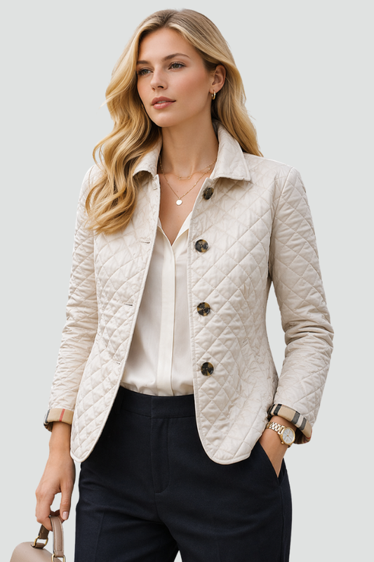 Woman wearing a diamond quilted jacket with point collar, four front buttons and check-lined cuffs over a blouse and tailored trousers._0