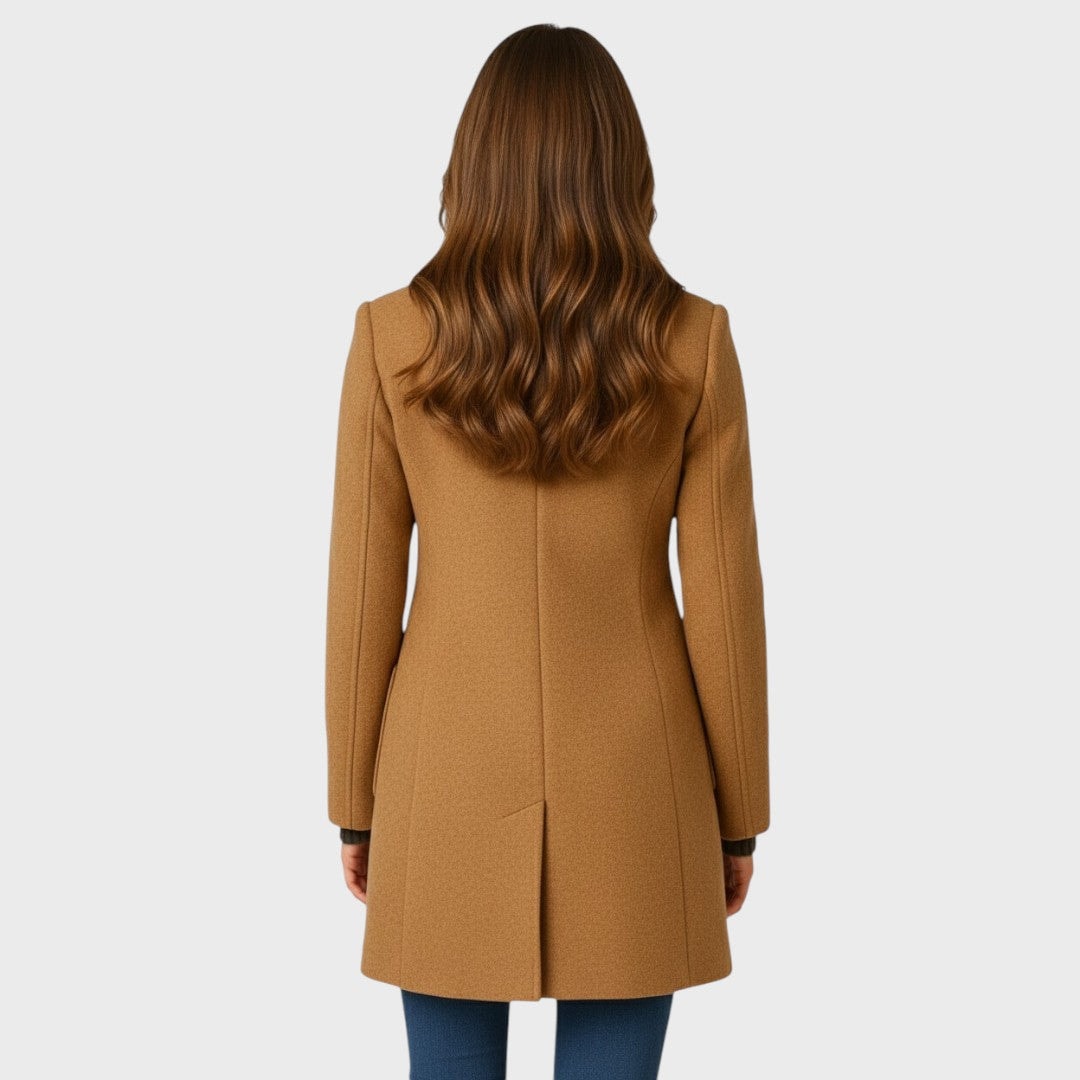 Back view of the camel fitted coat showing the clean long-sleeved silhouette, center back seam, and mid-length hem.