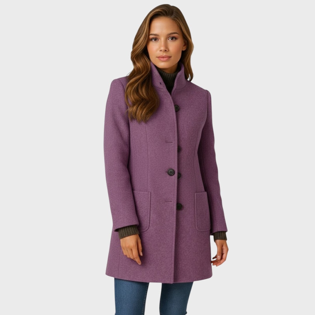 Front view of the purple fitted coat with a tall stand collar, dark front buttons, long sleeves, and two rectangular patch pockets.