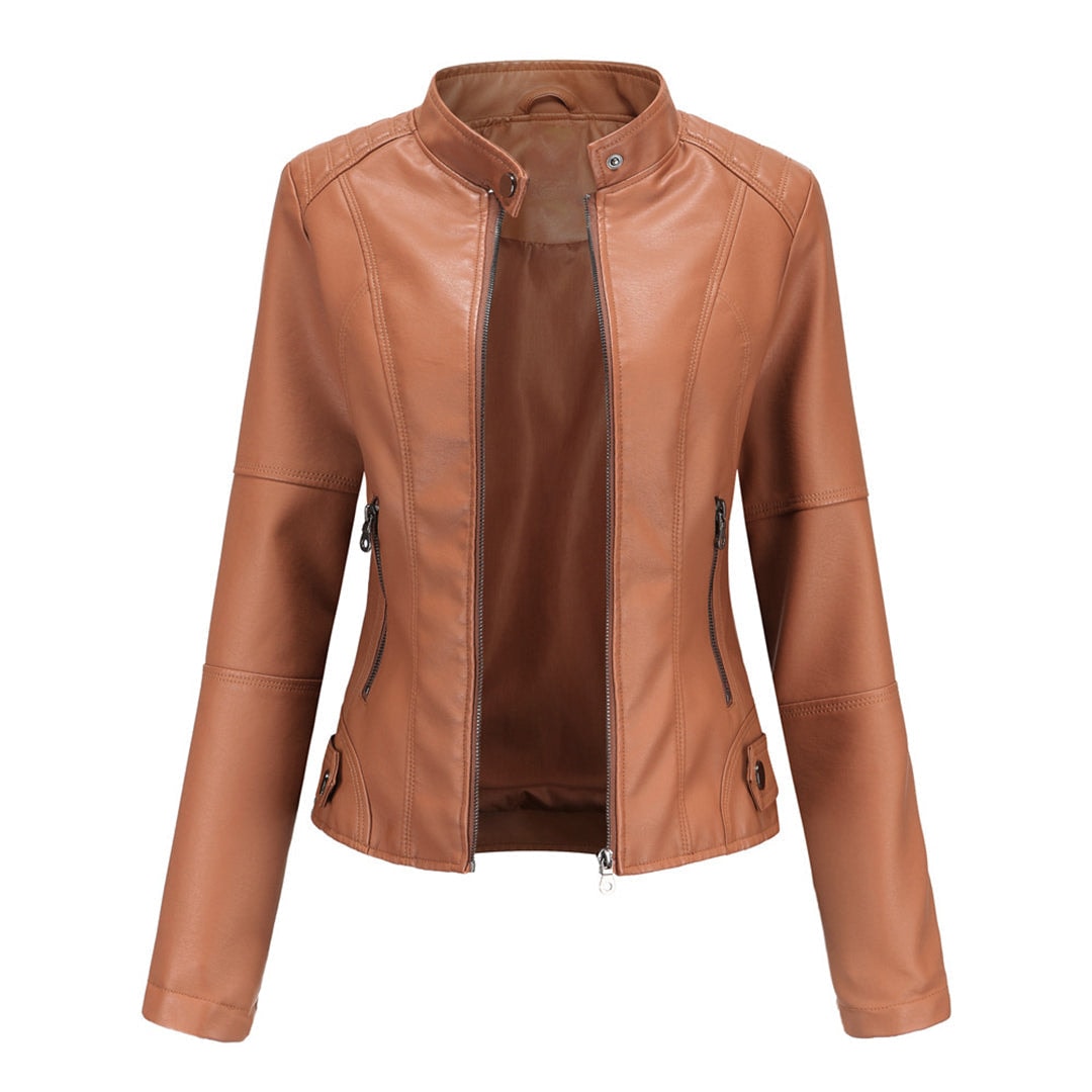 Tan fitted moto jacket featuring a stand collar, front zipper, curved panel seams, and zipped side pockets.