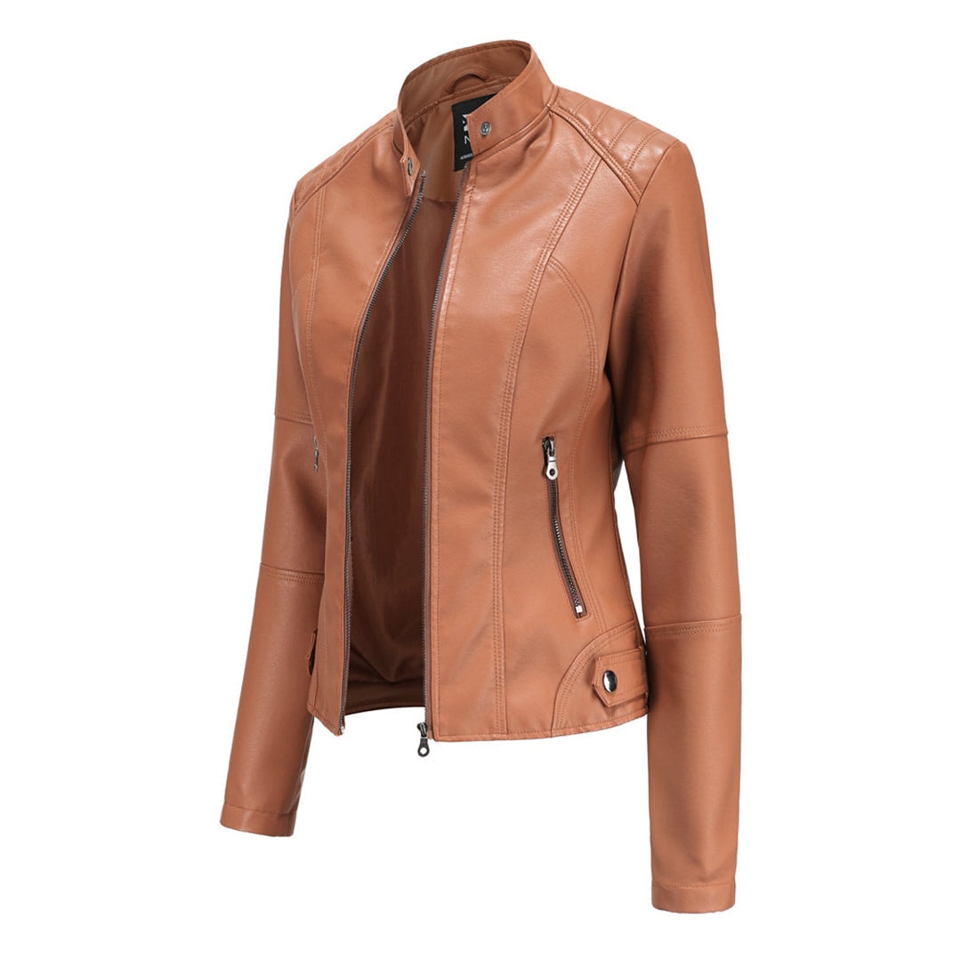 Tan moto jacket shown at an angle, highlighting its raised collar, open front zipper, fitted shape, and side pocket zippers.