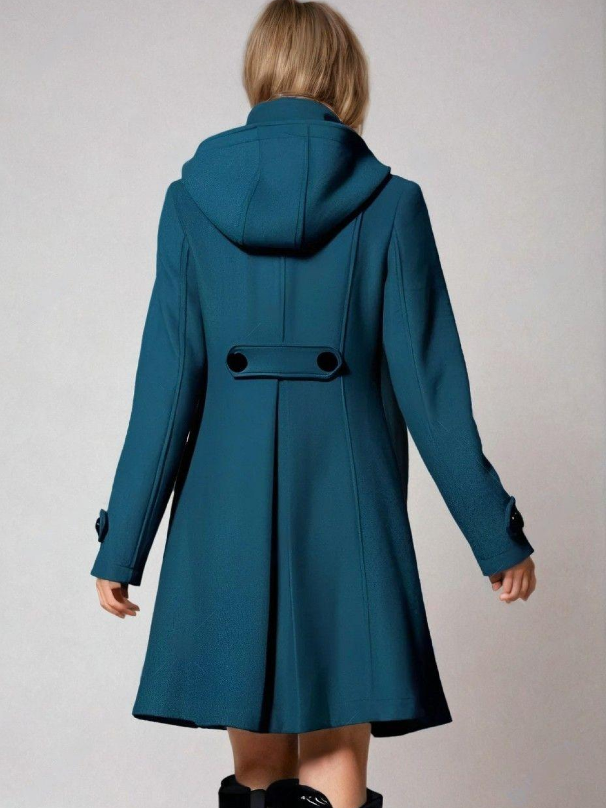 Back view of the teal hooded A-line coat, featuring a centered back seam and a buttoned waist tab.