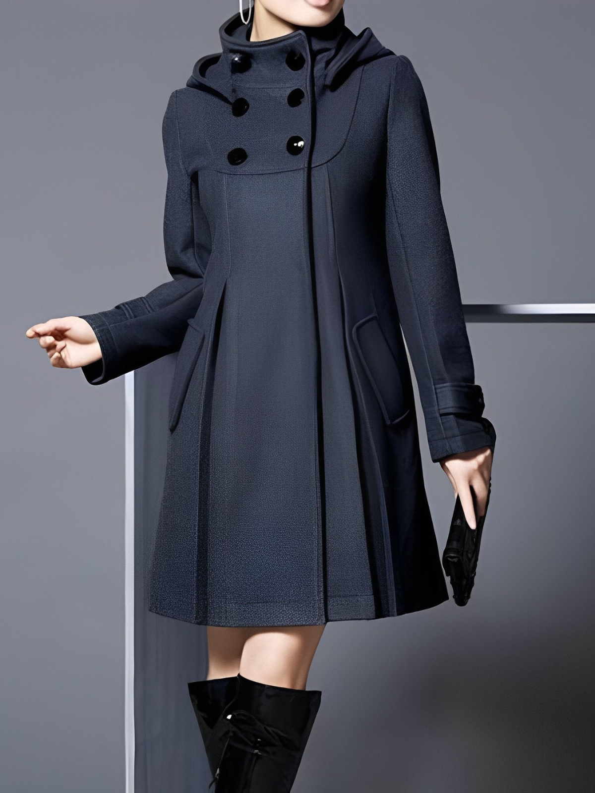 Front view of a dark navy funnel-neck hooded A-line coat with double-breasted buttons, angled pockets, and cuff details.
