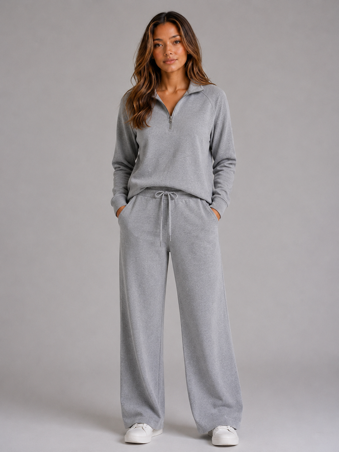 Front view of the matching lounge set in gray, with a collared half-zip top and drawstring wide-leg trousers.
