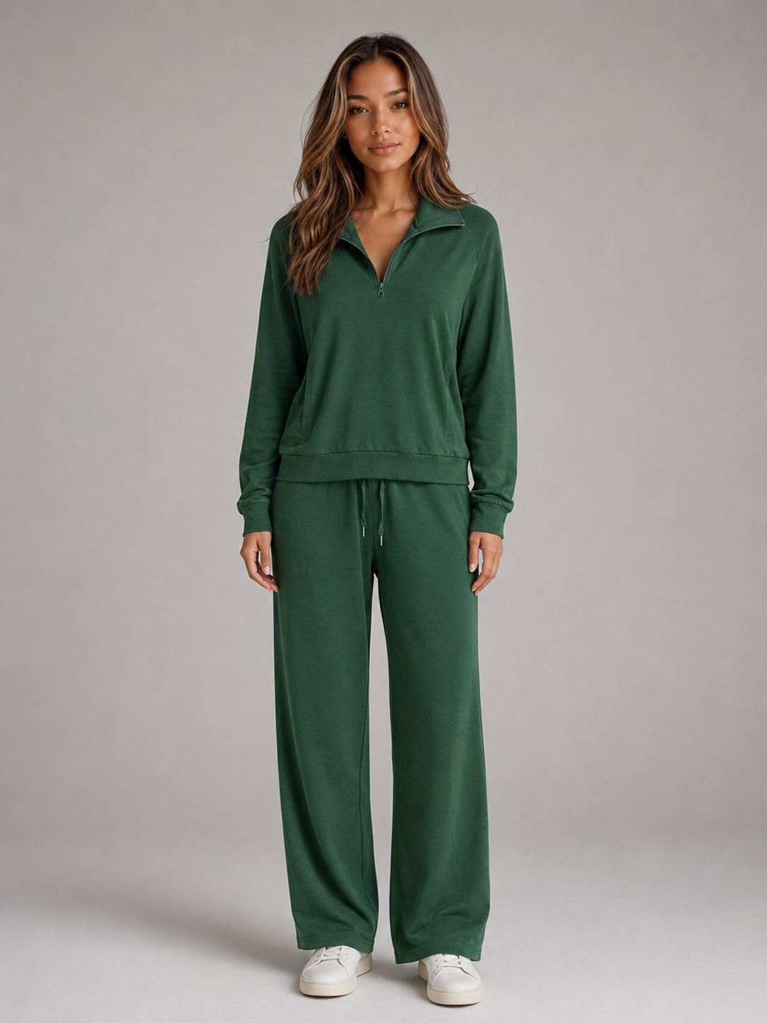 Front view of the matching lounge set in dark green, showing the half-zip sweatshirt and straight-hanging wide-leg trousers.
