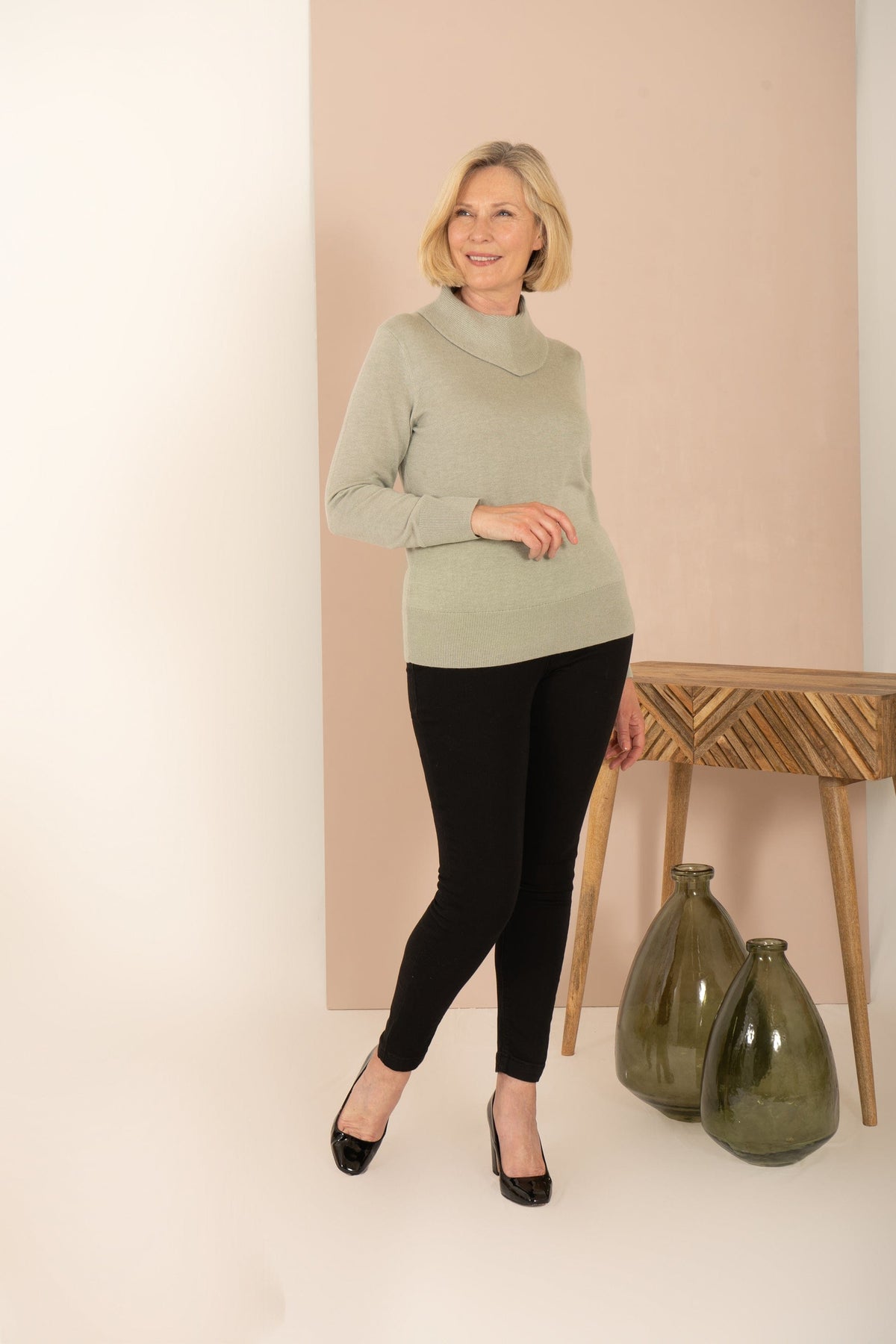 Woman wearing a long sleeve fine knit jumper with a draped cowl neck, ribbed cuffs and hem, with a printed midi skirt._5