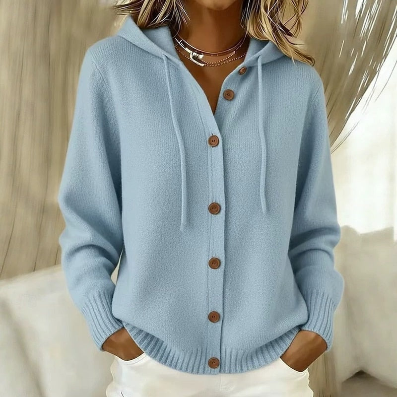 Light blue hooded cardigan featuring a row of brown buttons, drawstrings, long sleeves and ribbed edging.