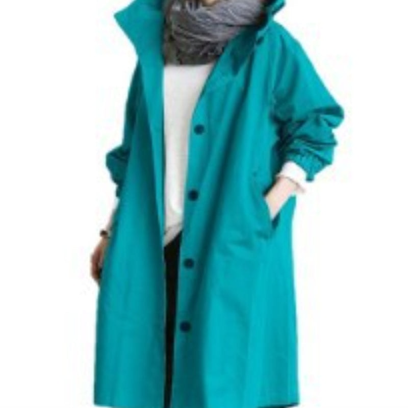 Teal hooded longline coat shown from the front with dark buttons, raised collar, gathered sleeves, and large side pockets.