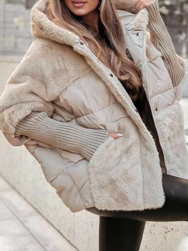 Close view of a cream hooded puffer jacket with plush fur panels, quilted sections, and long ribbed sleeves.