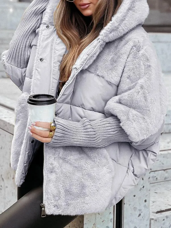 Close-up of the gray jacket showing the plush hood and sleeve, quilted waist section, zipper, and ribbed cuff.
