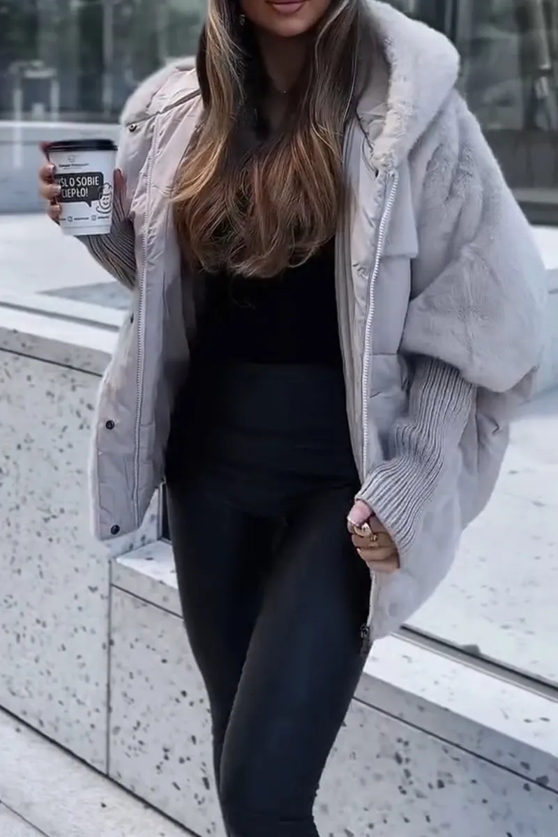 Light gray jacket styled in motion, with its hood, plush sleeve panels, ribbed cuffs, and open front visible.